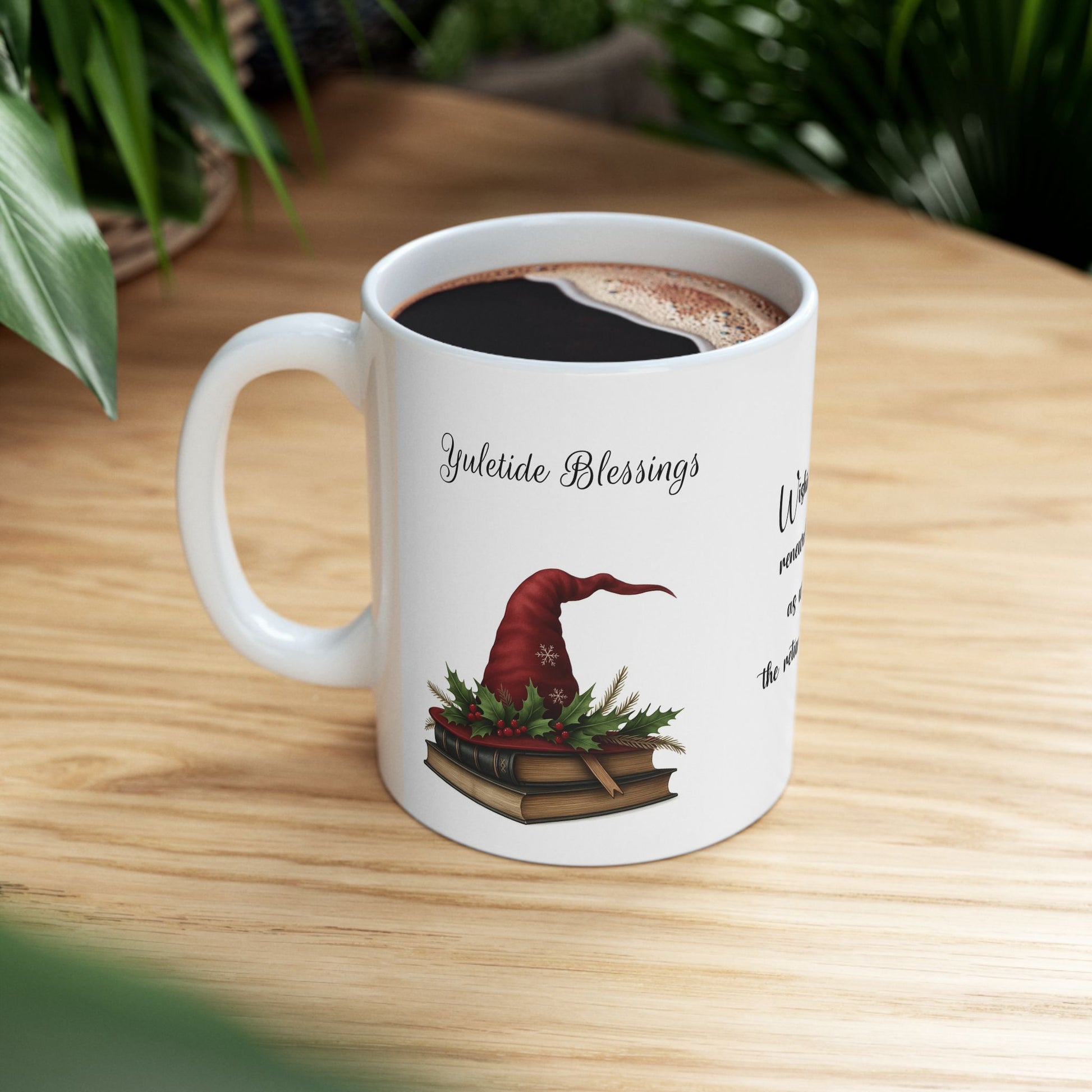 White ceramic mug with a festive Yuletide Blessings design on a wooden table