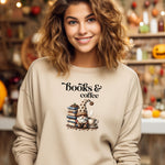 Sand Gildan sweatshirt featuring an adorable “Books & Coffee” design with a cozy gnome wearing a polka-dot hat, sitting beside a stack of books, a steaming coffee cup, and scattered coffee beans. A charming and whimsical design perfect for book lovers, coffee enthusiasts, and fall vibes.