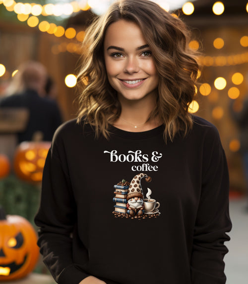 Black Gildan sweatshirt featuring an adorable “Books & Coffee” design with a cozy gnome wearing a polka-dot hat, sitting beside a stack of books, a steaming coffee cup, and scattered coffee beans. A charming and whimsical design perfect for book lovers, coffee enthusiasts, and fall vibes.
