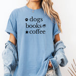 Black graphic design on a Washed Denimn t-shirt featuring the phrase “Dogs, Books, Coffee” in bold, playful lettering. Decorative icons of a dog paw, stacked books, and a steaming coffee cup enhance the cozy, laid-back vibe—perfect for dog lovers, bookworms, and caffeine enthusiasts alike.