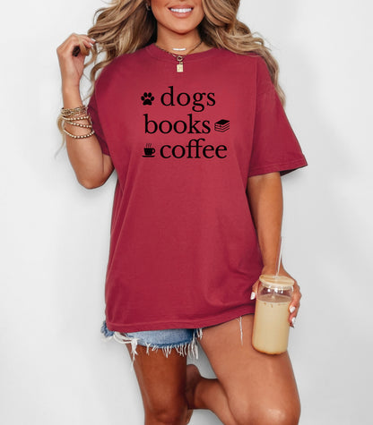 Black graphic design on a Chili t-shirt featuring the phrase “Dogs, Books, Coffee” in bold, playful lettering. Decorative icons of a dog paw, stacked books, and a steaming coffee cup enhance the cozy, laid-back vibe—perfect for dog lovers, bookworms, and caffeine enthusiasts alike.
